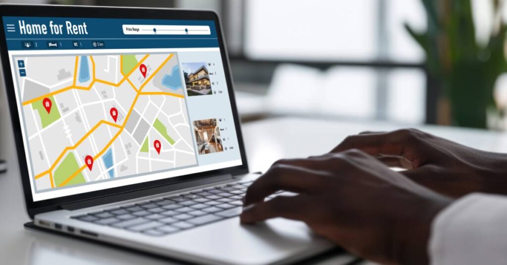 A website titled "Homes for Rent" on a laptop screen with a map displaying available property listings.