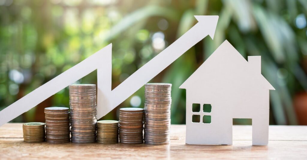There are six stacks of coins of varying heights beside a cutout of a house. A white arrow points upward above the coins.
